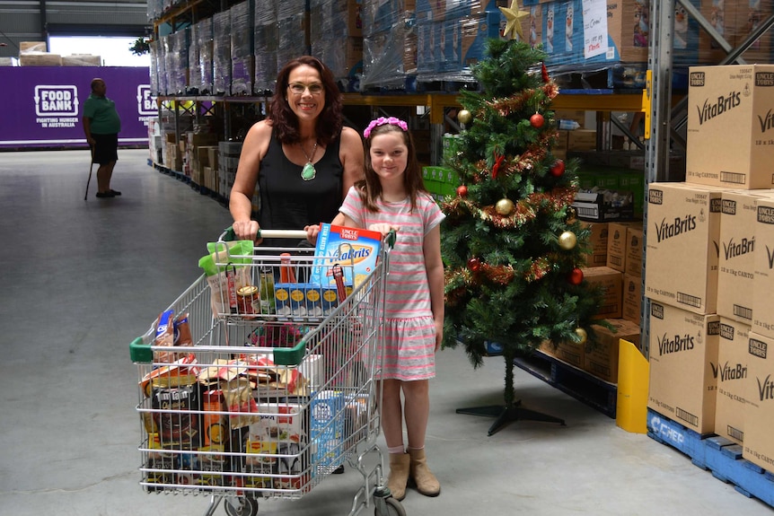 Allsion Marshall and her granddaughter with a shopping trolley at Foodbank.
