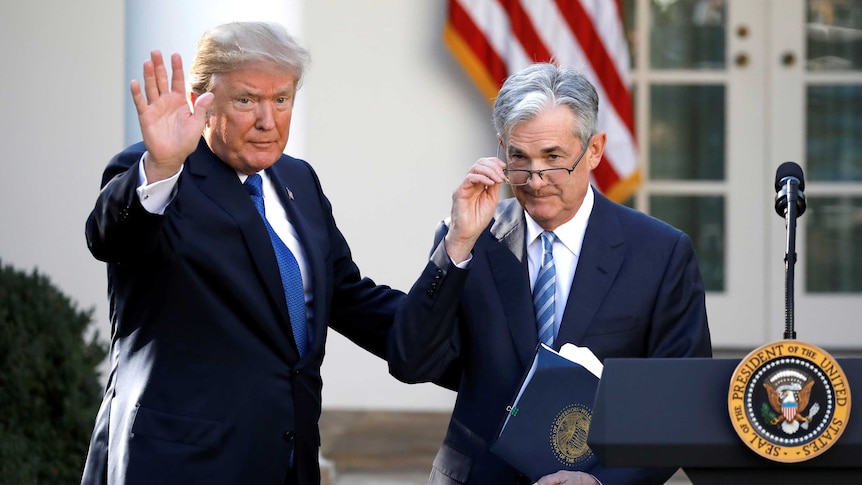 US President Donald Trump gestures with Jerome Powell