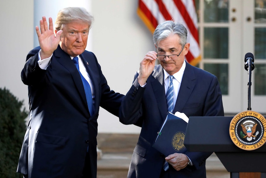 US President Donald Trump gestures with Jerome Powell