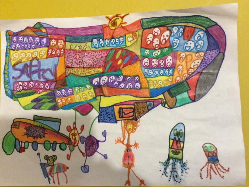 A child's drawing of a ship with lots of faces on it, surrounded by monsters and animal figures.