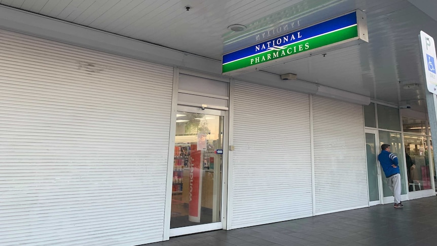 National Pharmacies Findon with roller doors closed over its windows.