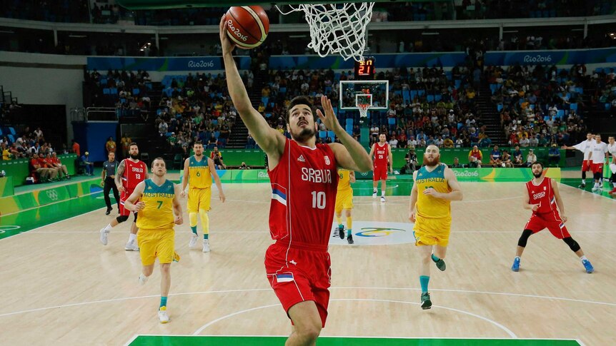 Serbia's Nikola Kalinic rises off his left foot, raising the ball towards the basket as chasing players look on behind him