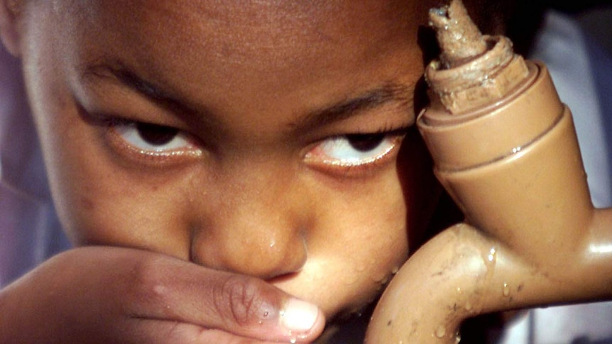 Child drinks from tap