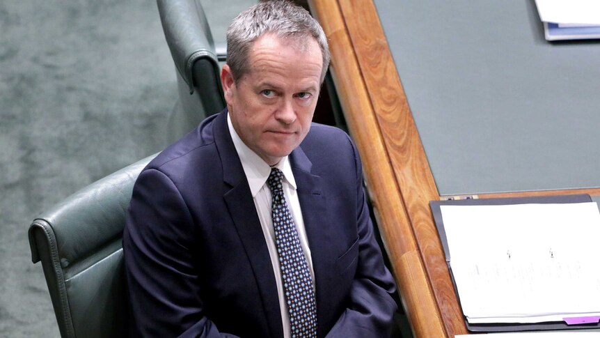 Bill Shorten looks up as he sits in the House of Representatives.