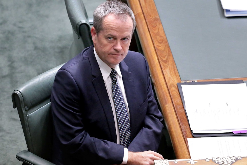 Bill Shorten looks up as he sits in the House of Representatives.