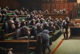 Two people stand on ladders holding up a huge painted canvas depicting hundreds of chimpanzees sitting in the British Parliament