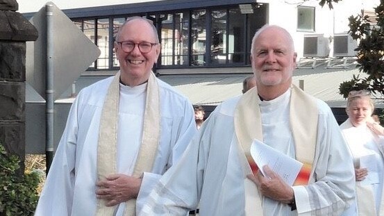 Father John Davis and Father Rob Whalley walking in their clerical vestments