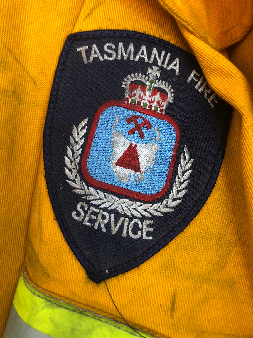 Tasmania Fire Service insignia badge on yellow jacket.