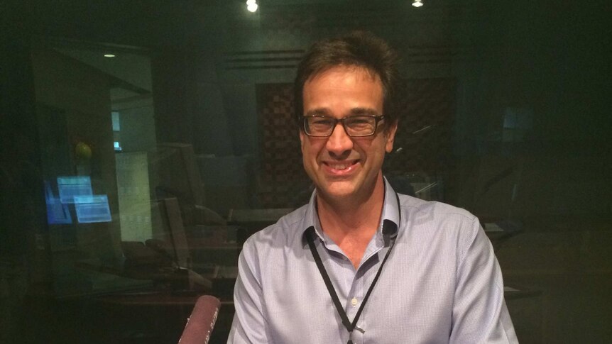 A portrait photo of Paul Evans, CEO of the Winemakers Federation of Australia sitting in radio studio