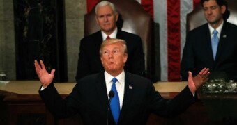 Donald Trump raises his arms, looks to the ceiling and pulls a coy face during the state of the union address
