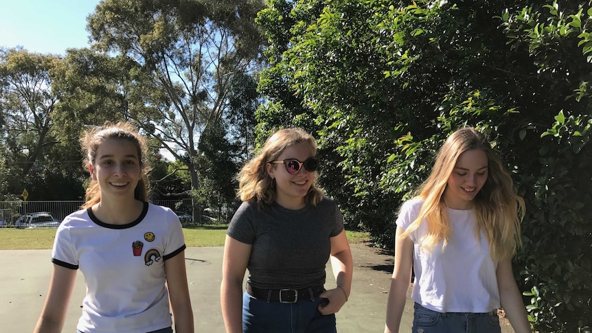 Ariana Costas, Stella Conlon, Bella Bauer walking in a park.