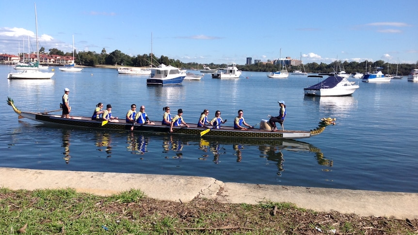 People in a dragon boat on Parramatta River.