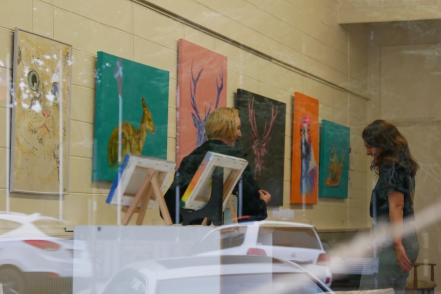 people inside a gallery looking at art