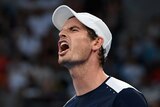 Andy Murray grimaces on court, clenching his hand in frustration after losing a point