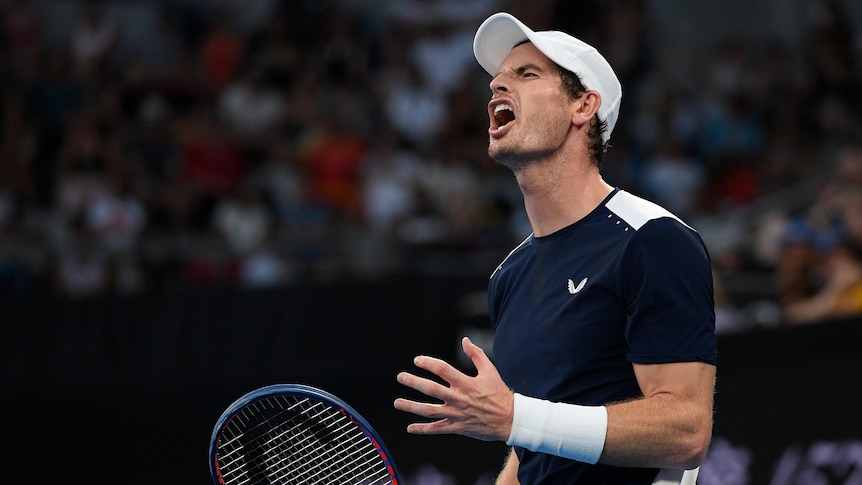 Andy Murray grimaces on court, clenching his hand in frustration after losing a point