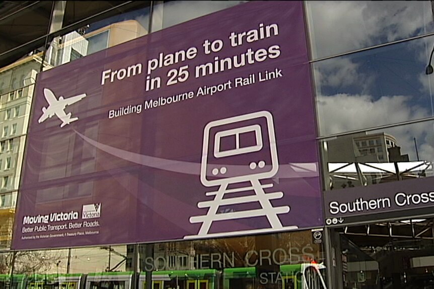 A banner outside a train station advertising a train line to Melbourne Airport