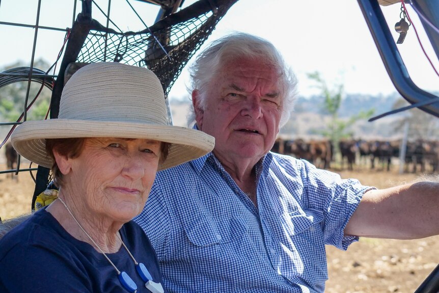 A photo of Paula and David Stevenson on a farm buggy on the farm near Scone in New South Wales, September 2023.