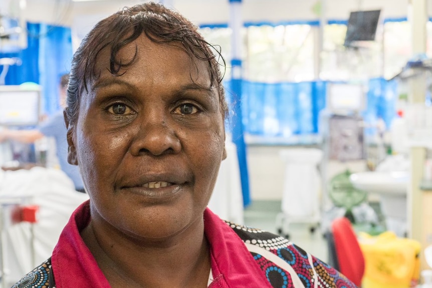 Close up of Indigenous woman standing in a renal dialysis unit