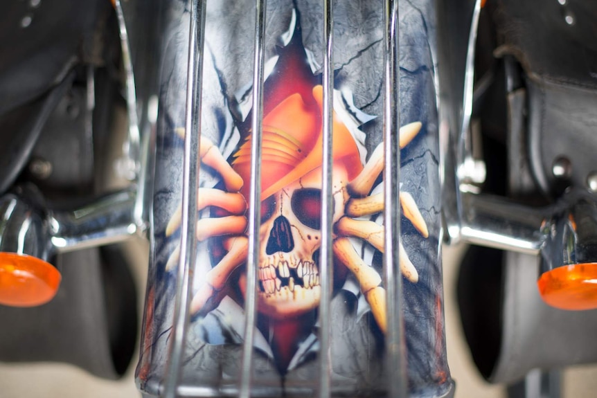 A customised paint job features the skeleton of a digger climbing out of the rear fender of Roy 'Shorty' Mawers' motorcycle.