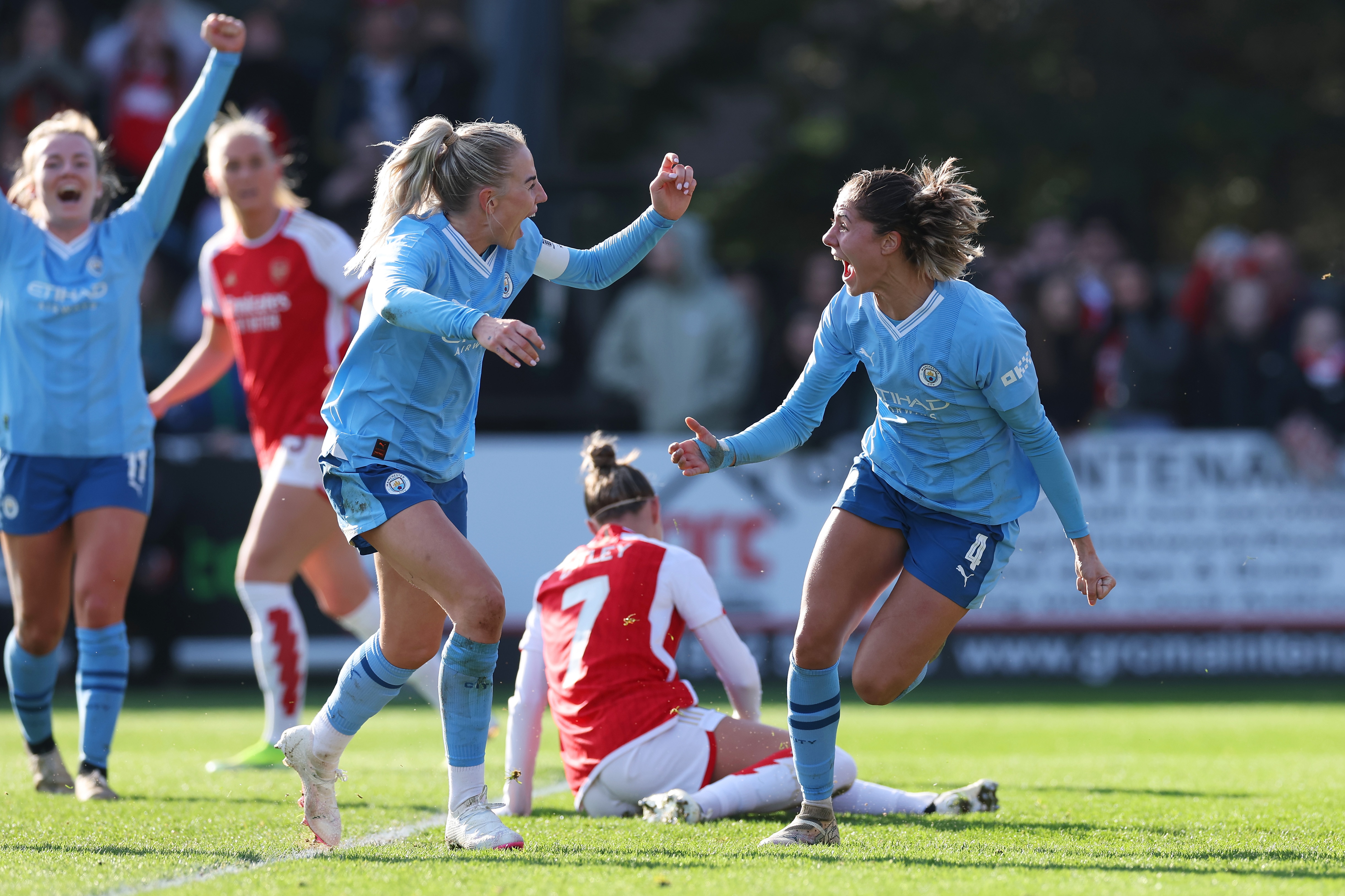 Chloe Kelly and Laia Aleixandri celebrate a Manchester City goal against Arsenal.