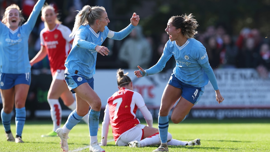 Chloe Kelly and Laia Aleixandri celebrate a Manchester City goal against Arsenal.
