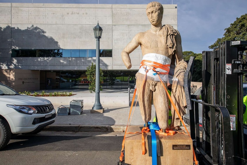 A statue of a man on a forklift