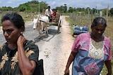 Sri Lankan Tamil villagers flee from their homes after the funeral of Baskaran at Kanniya