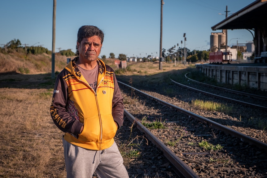 Lloyd Munro stands on the tracks at the Moree train station.
