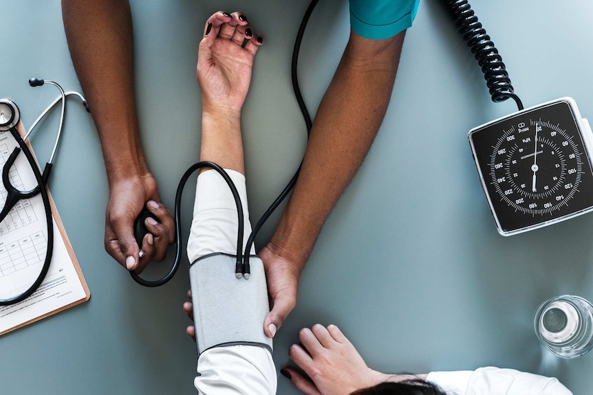 A person gets their blood pressure tested.