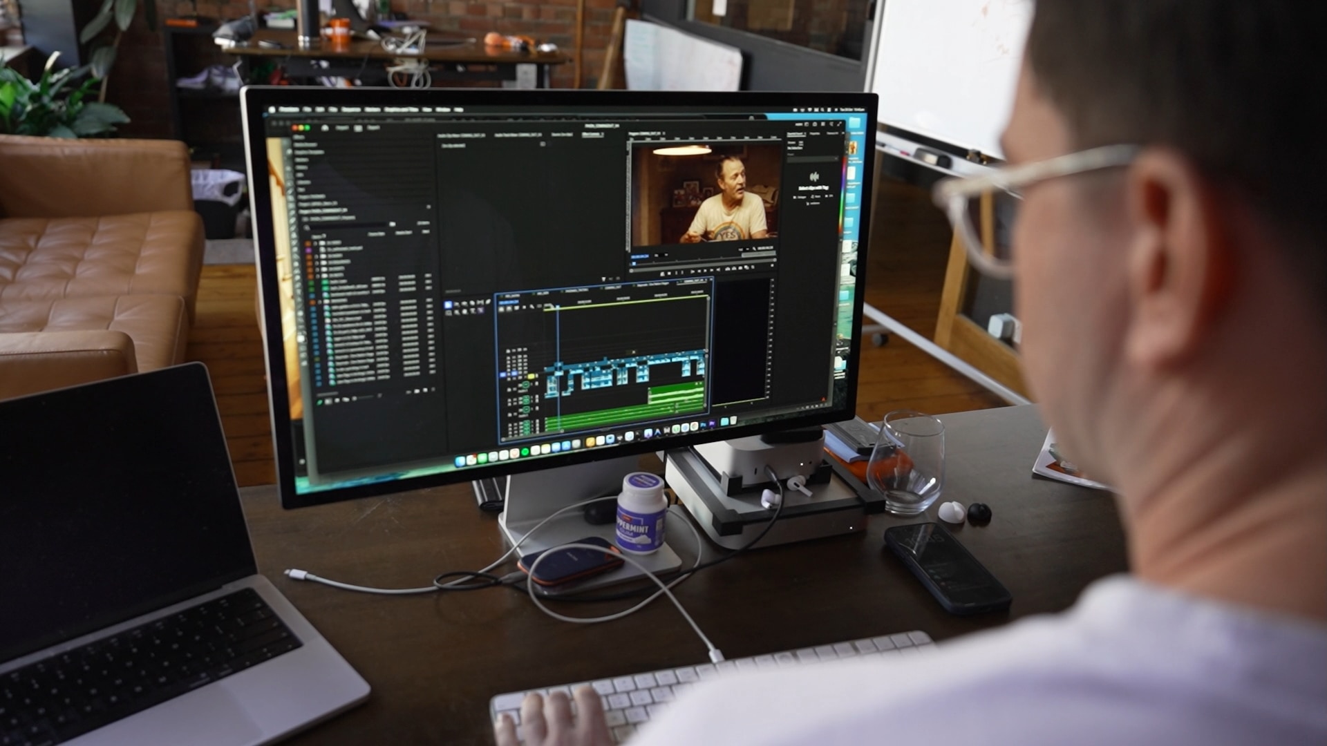 A man editing a video at a desk.