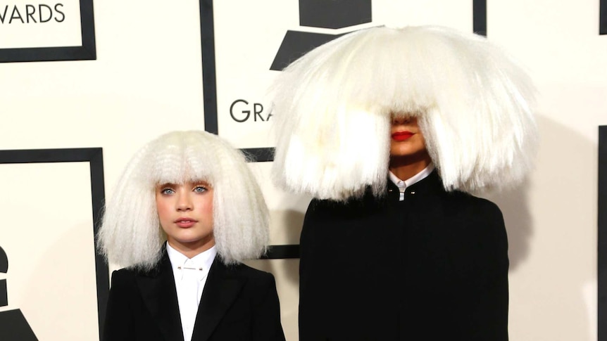 Singer Sia and Dance Moms star Maddie Ziegler arrive at the 57th annual Grammy Awards in Los Angeles, California February 8, 2015.