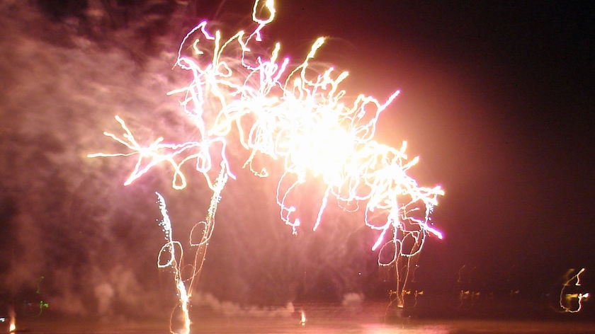 Revellers let off fireworks on Darwin's Mindil Beach.