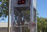 A clock tower shows 41C on the temperature gauge.