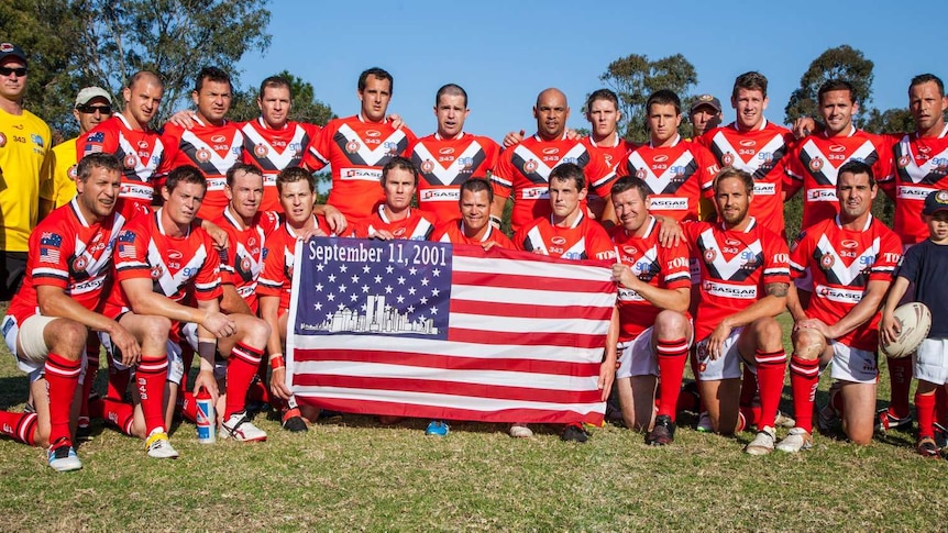 Players pose for a photograph with a US flag reading September 11 2001
