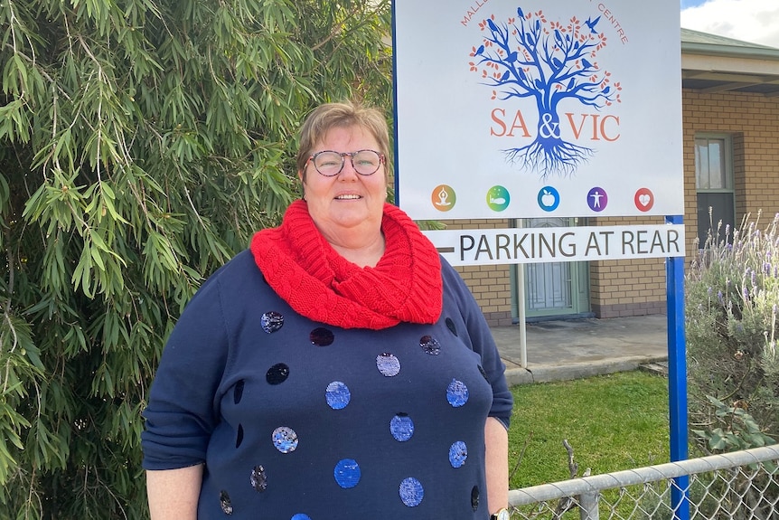 Di Thornton, a woman wearing red and blue standing outside.