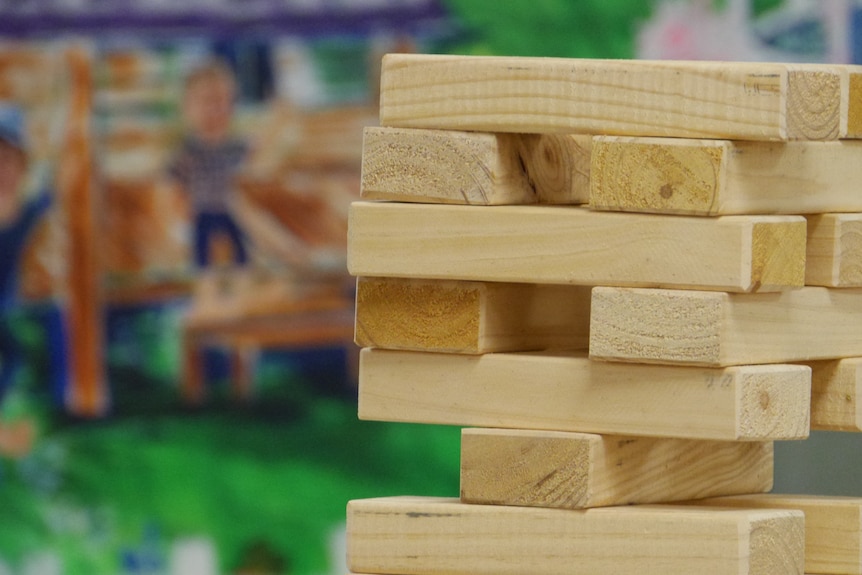 Light coloured wooden blokes stacked in a game. 