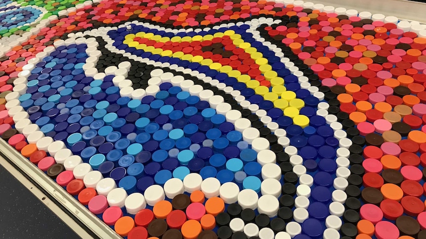 An artwork made of different coloured drink lids in recognition of the Biripi people.