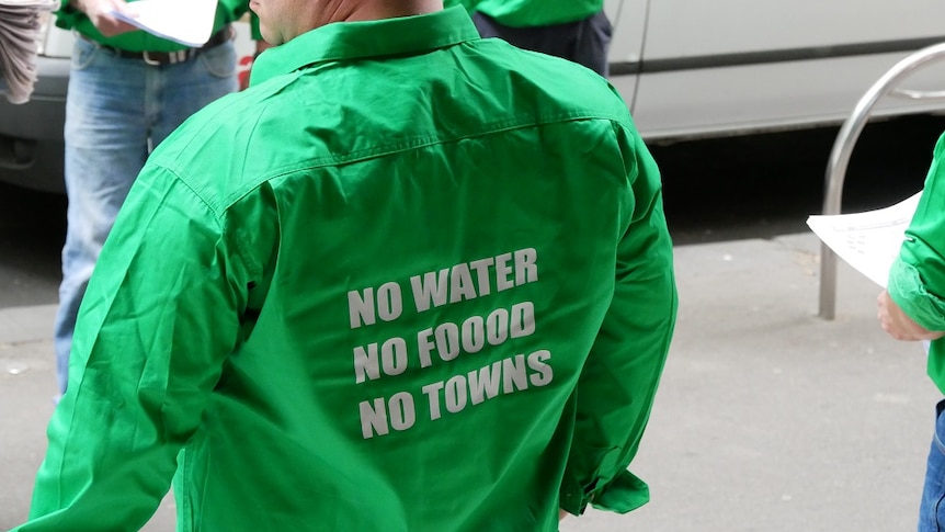 A the back of a green shirt reads no water no food no towns