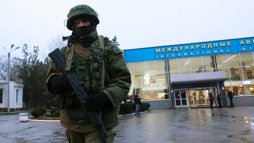 Armed man patrols Ukraine's Simferopol airport