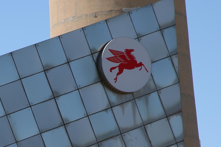A Mobil building with the logo of a red pegasus on it.