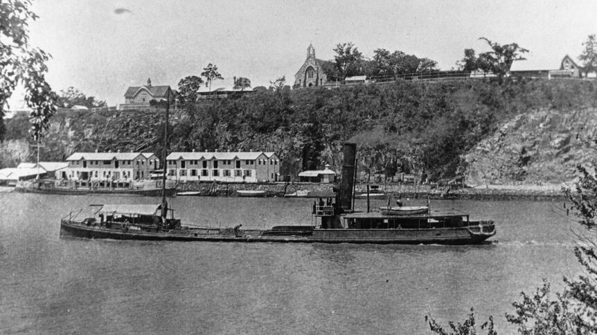 A historical photo of a steamship near naval stores.
