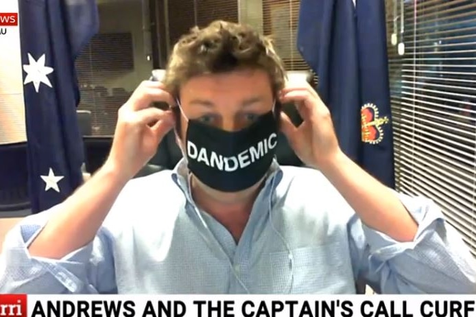 Tim Smith wears a black face mask with the word DANDEMIC written on it