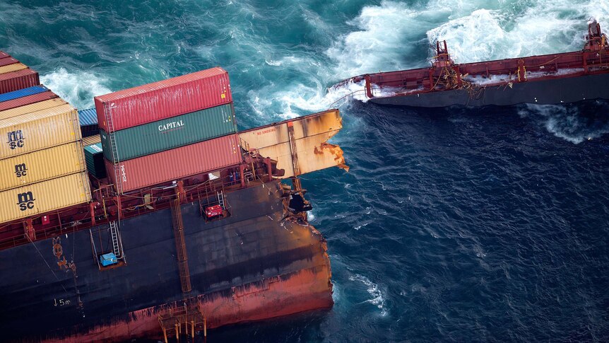 Waves crash over the stricken container ship Rena