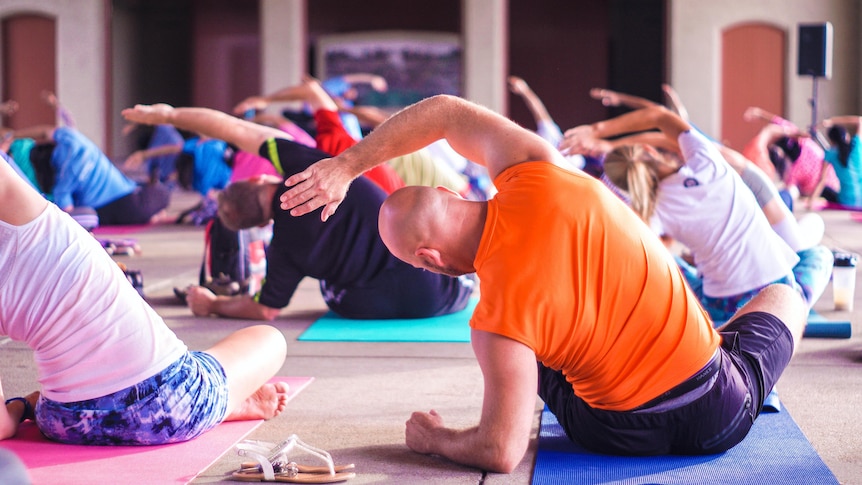 A generic shot of a colourful yoga class.