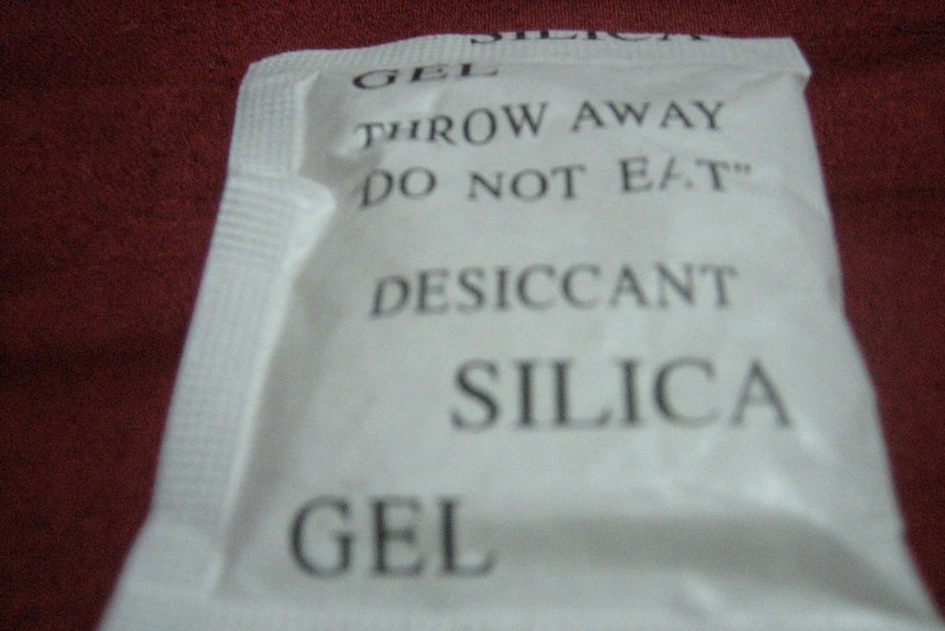 Small packet of desiccant silica gel with warning, "Throw away. Do not eat."