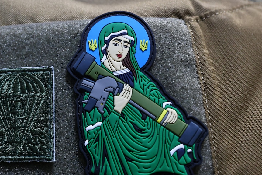 A patch on a US army uniform depicting the Virgin Mary holding a rocket launcher 