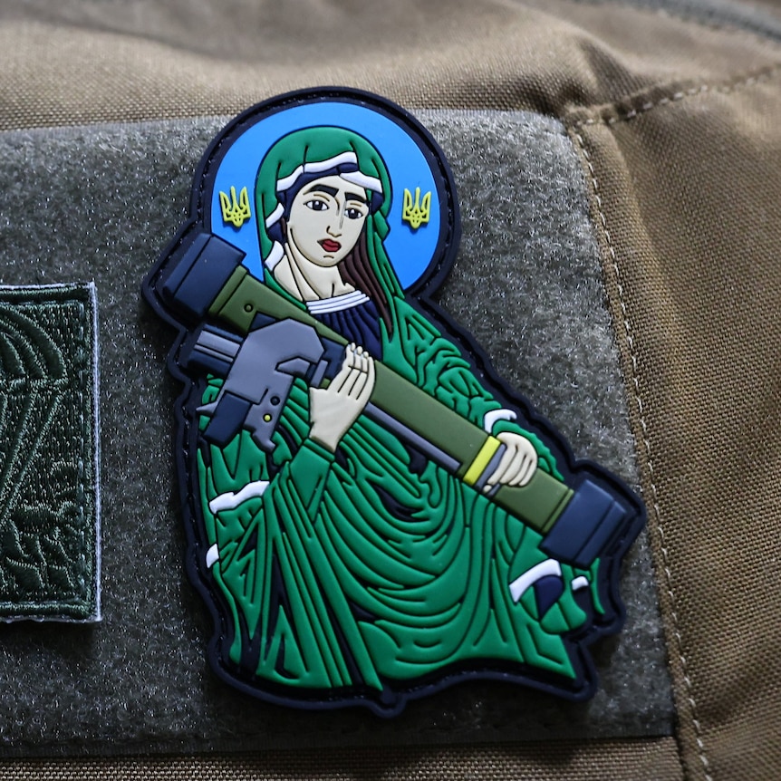 A patch on a US army uniform depicting the Virgin Mary holding a rocket launcher 