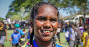 Young AFL player Darliah Killer smiles into the camera.