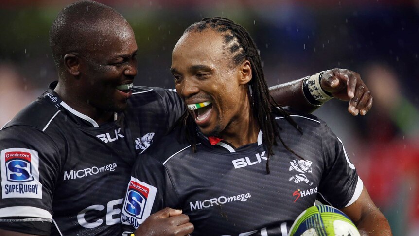 Lubabalo Mtembu (L) congratulates Odwa Ndungane of the Sharks for his try against the Lions.