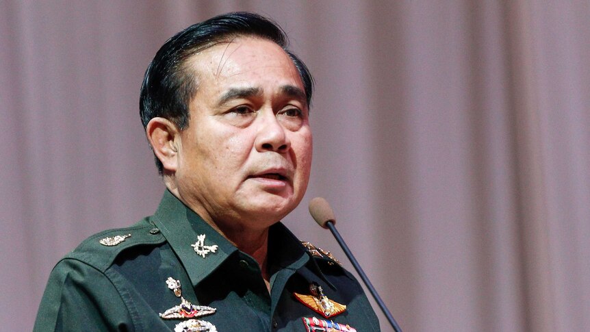 Thai Army chief General Prayut Chan-O-Cha speaking in front of a microphone